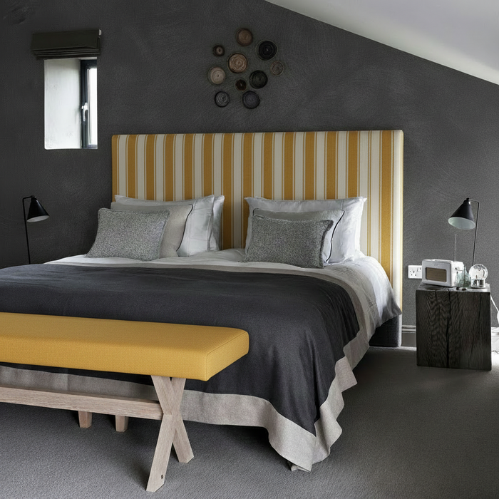 Masculine Bedroom - Mustard Ottoman with Pinstripe Headboard and Charred Plaster Wallpaper