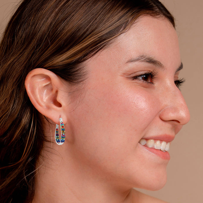 Model wearing Crystal Small Hoop Earring by Mosaico Jewels, highlighting the earring's colorful bead details and elegant design.