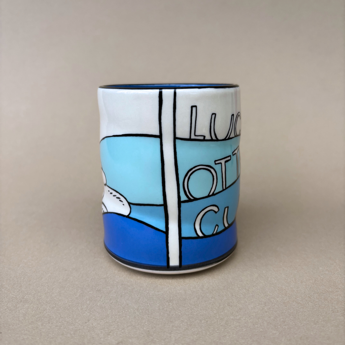 Lucky Otter Cup displaying a side view with artistic text and ocean hues, created by The Bowl Maker.