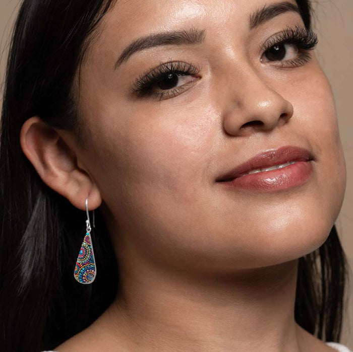 Model wearing Morning Drop Earrings by Mosaico Jewels, featuring vibrant colors and detailed patterns, highlighting the earring's elegance and style.