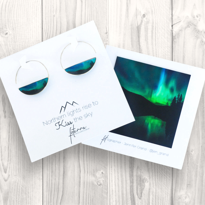 Handcrafted Northern Lights Rise To Kiss The Sky Hoop Earrings by Foterra Jewelry, featuring crescent shapes and a unique waterproof resin design, displayed alongside stunning photography of the aurora borealis.