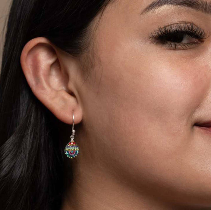 Model wearing Petite Dew Drop Earrings by Mosaico Jewels, showcasing the vibrant bead design and delicate silver hooks.