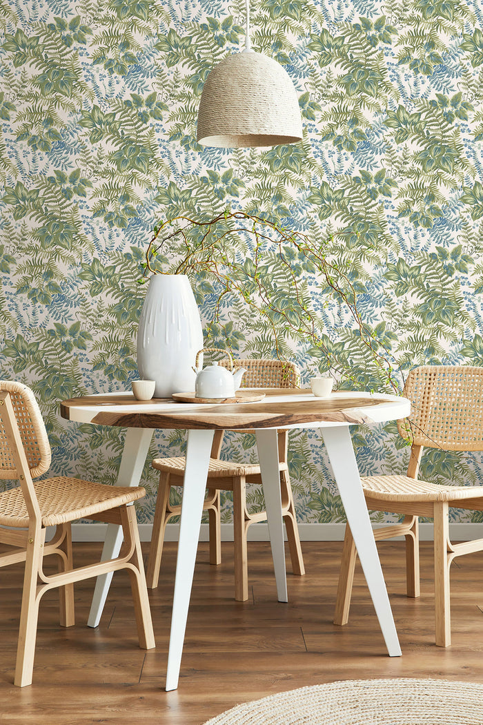 Rowan wallpaper in Cream/Sky Blue on a feature wall, dense hand-painted foliage