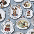 Blue wallpaper hung with white china plates holding animal portraits — flat pattern detail