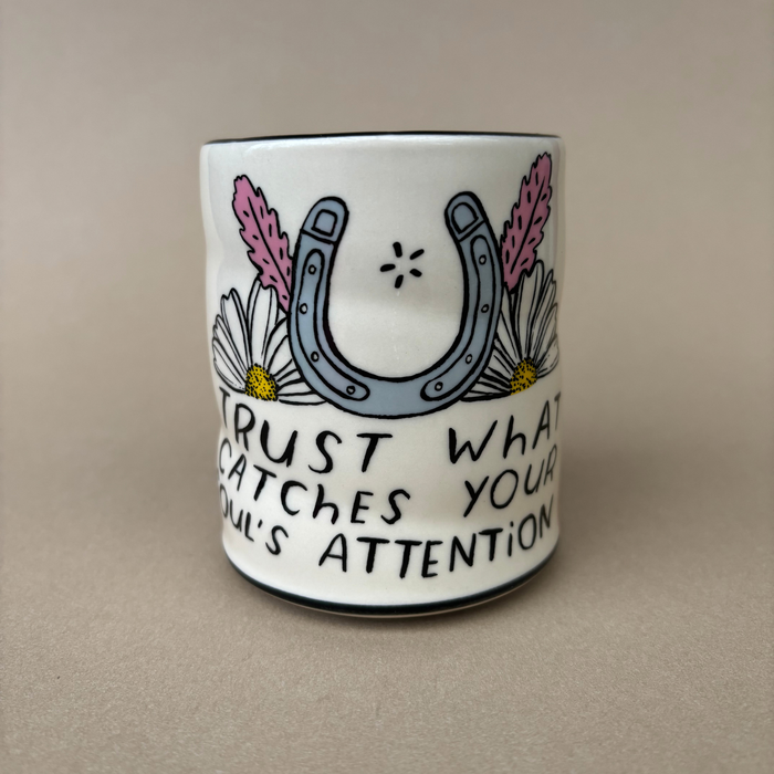 Trust Soul Spark Cup - Large showcasing a decorative white cup with a horseshoe design and the inspiring phrase 'Trust what catches your soul's attention,' created by The Bowl Maker.